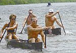 Two sets of canoe racers go head-to-head towards the finish