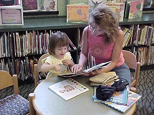 A mother reads a book with her child